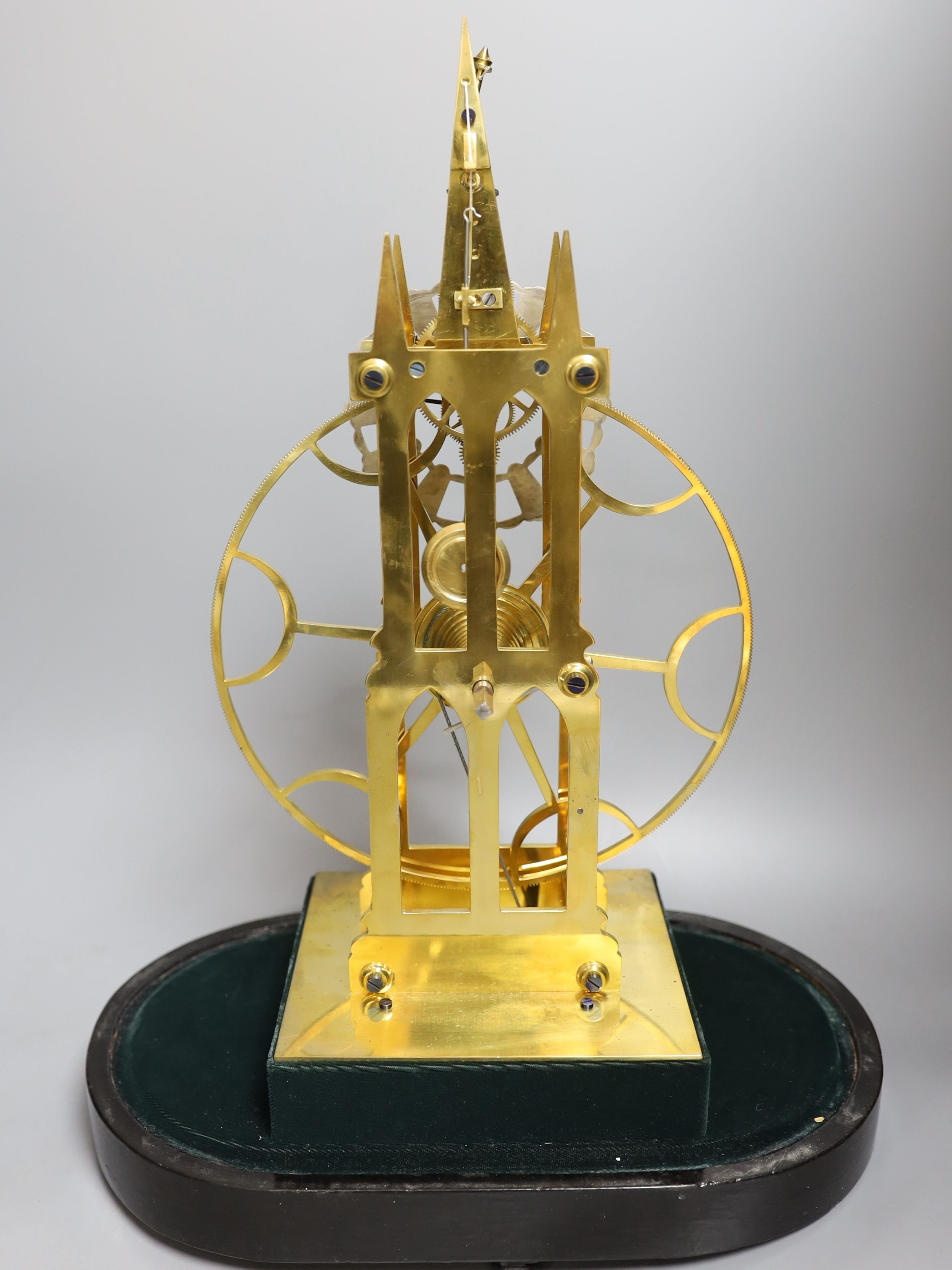 A brass skeleton fusee mantel timepiece, with large wheel, under glass dome on stand, 49cms high.